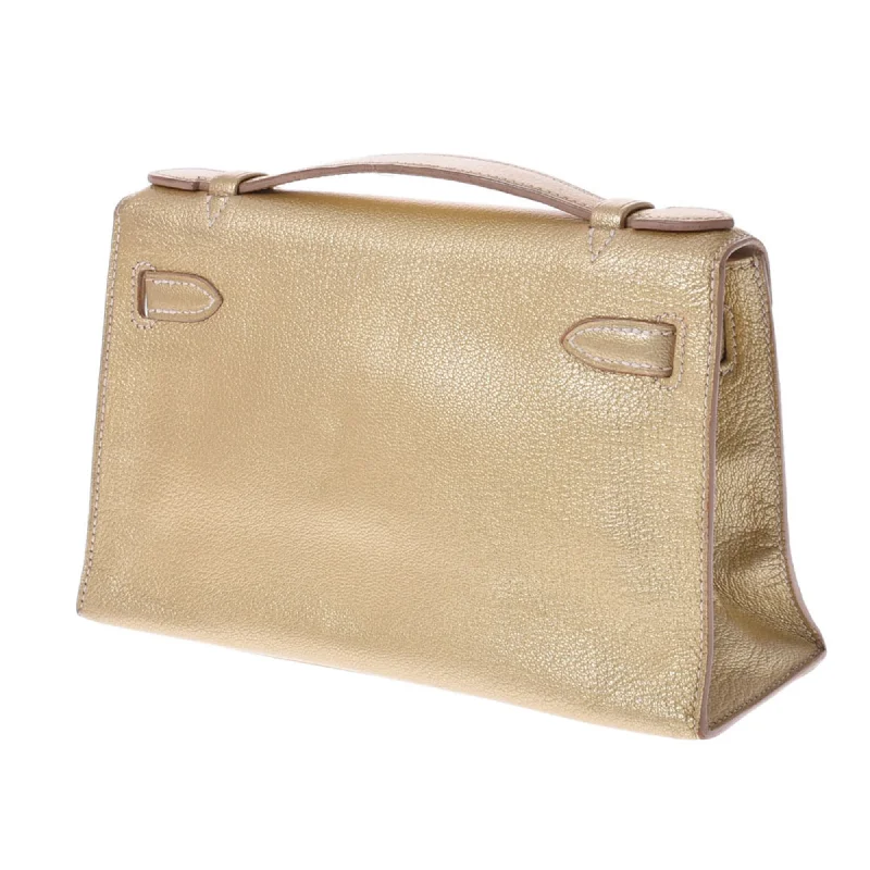 Hermès Kelly Bags with a two - tone leather design for visual interestHermes Pochette Kelly Metallic Gold  I Engraved (around 2005) Ladies Goat Chevre Handbag